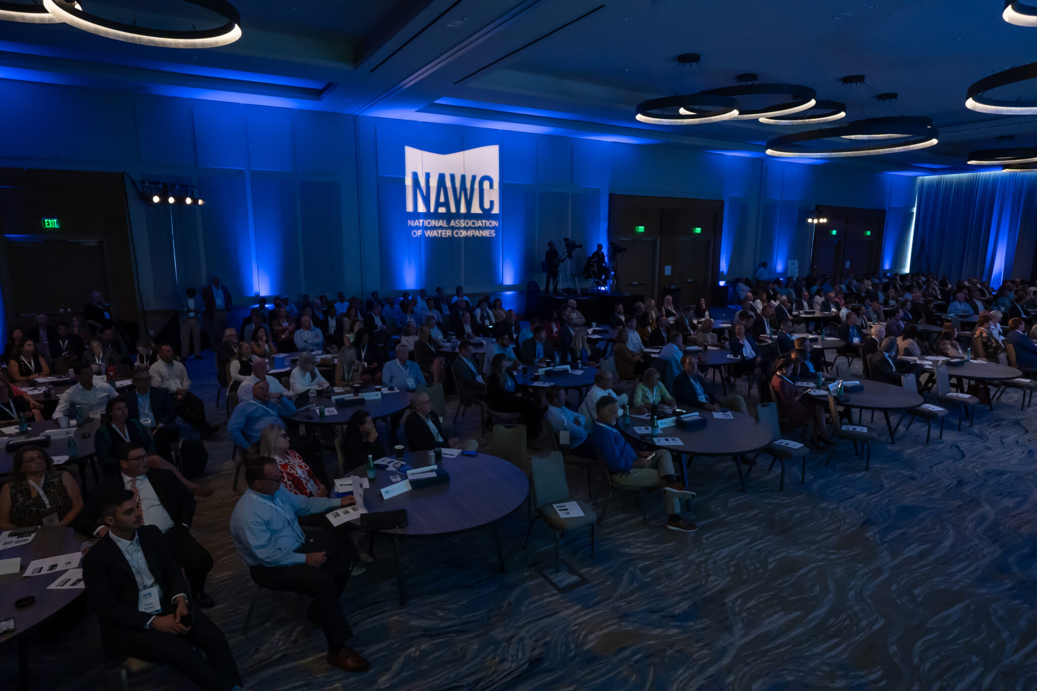 extended picture of the room at the water summit meeting showing people listening to speakers