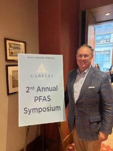 Rob Powelson in front of 2nd Annual PFAS Symposium sign